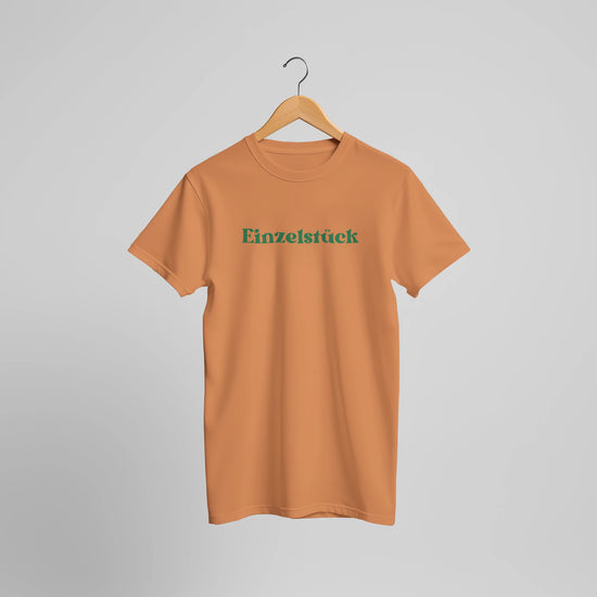 Unisex T-Shirt in gebranntem Orange aus hochwertiger Baumwolle mit grünem 